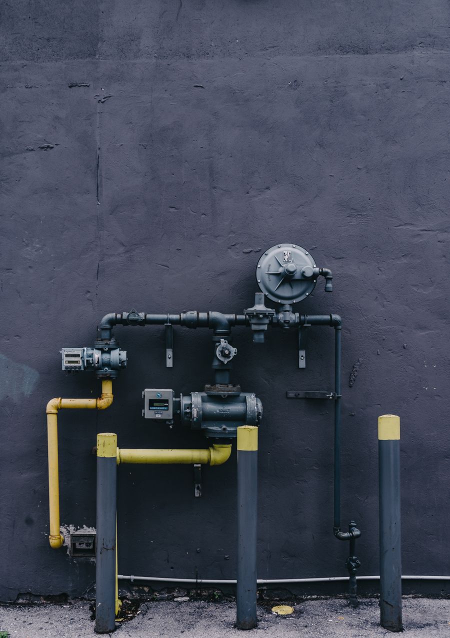 Plumber repairing a leaking water pipe